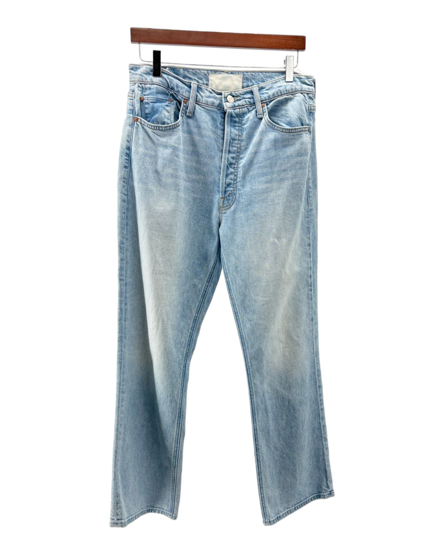 Light blue jeans on a hanger against a white background