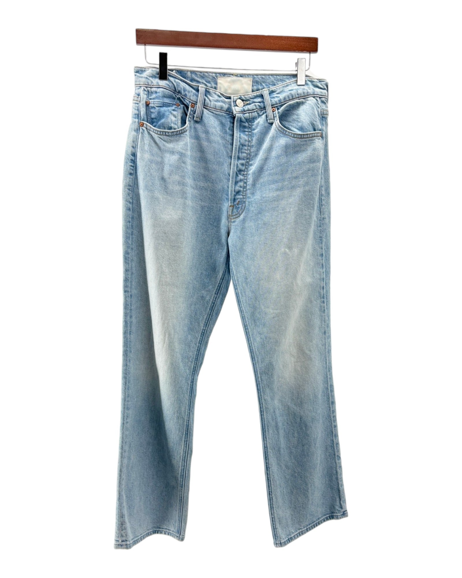 Light blue jeans on a hanger against a white background