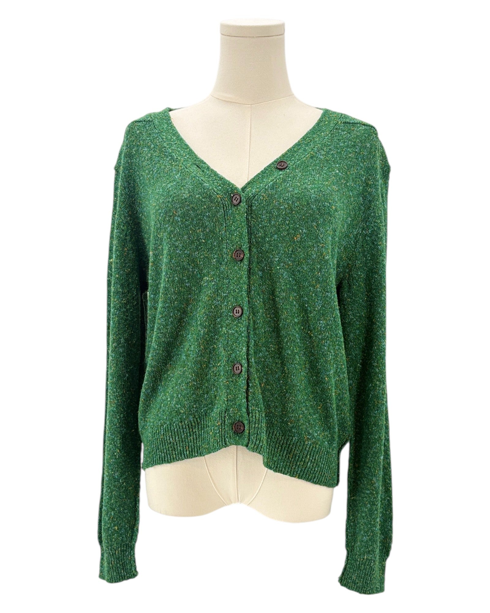 Green cardigan sweater on a mannequin against a white background