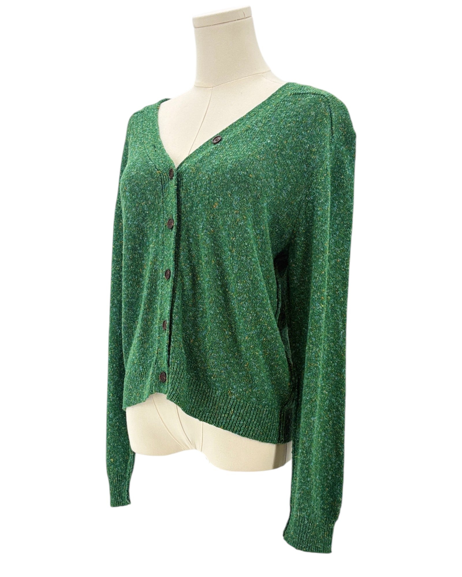 Green cardigan sweater on a mannequin against a white background