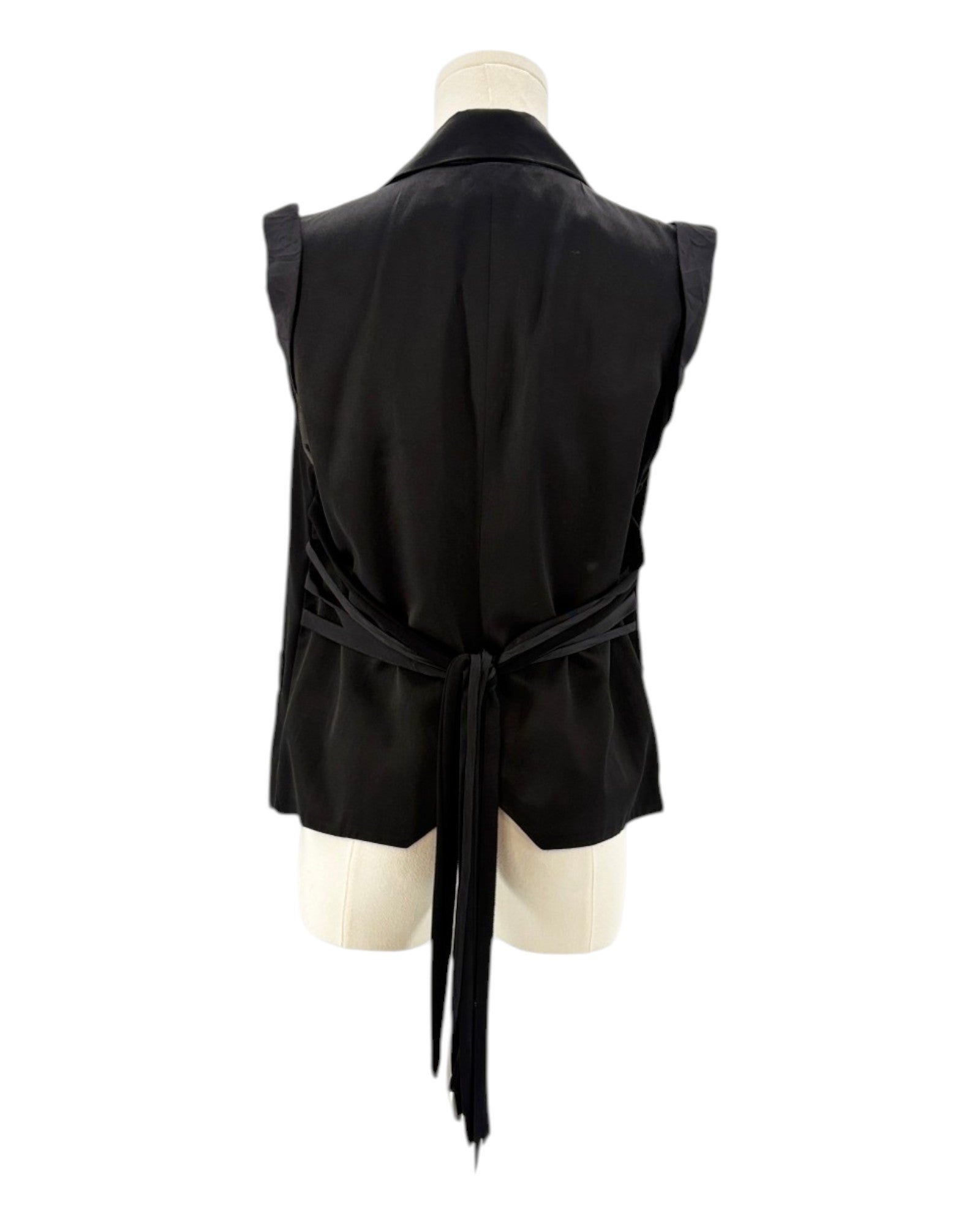 Nanette Lepore black sleeveless blazer with a tie waist on a mannequin against a white background