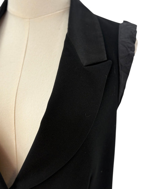 Nanette Lepore black sleeveless blazer with a tie waist on a mannequin against a white background