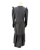 nation LA black dress with ruffled shoulders on a mannequin against a white background