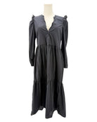 nation LA black dress with ruffled shoulders on a mannequin against a white background