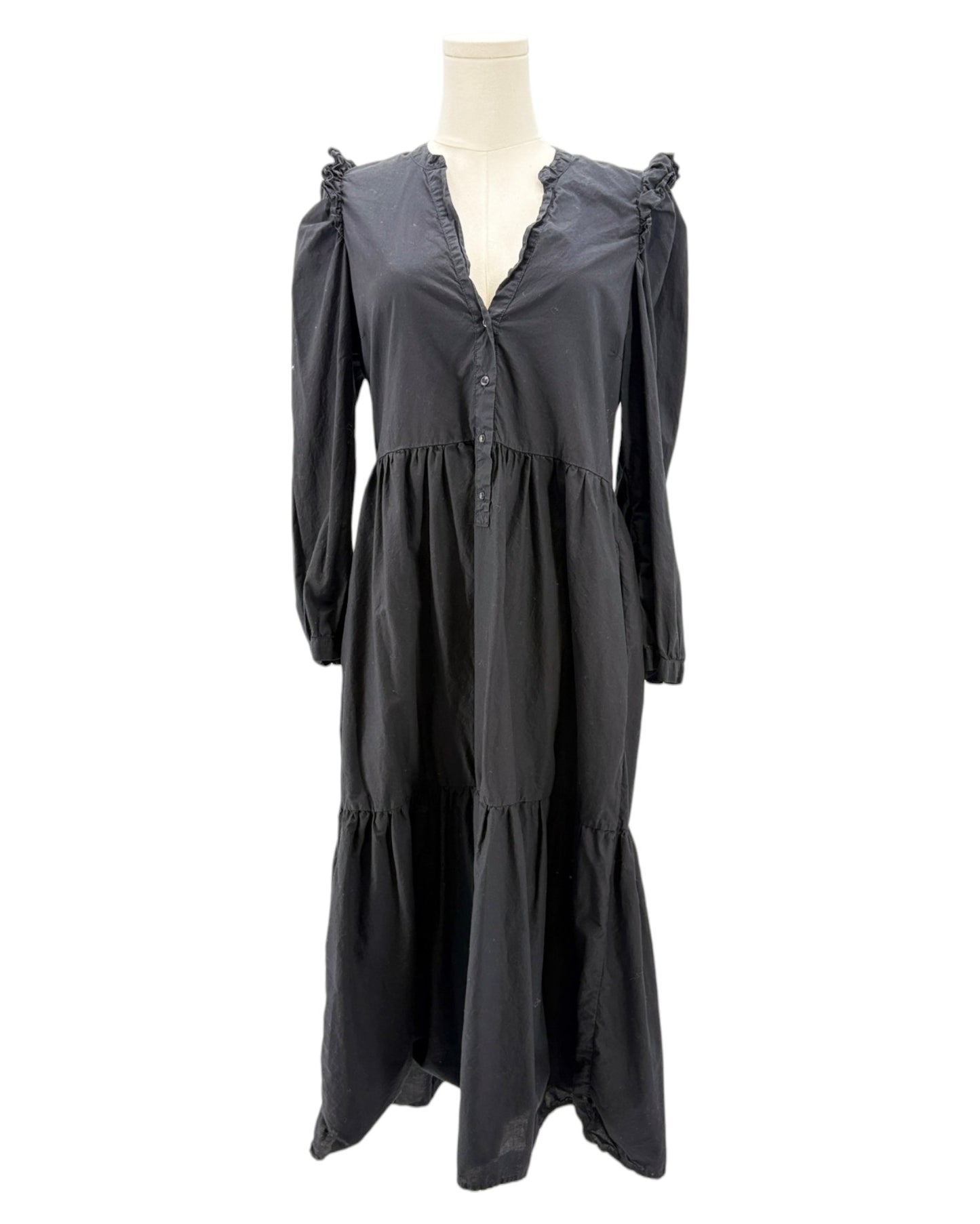 nation LA black dress with ruffled shoulders on a mannequin against a white background