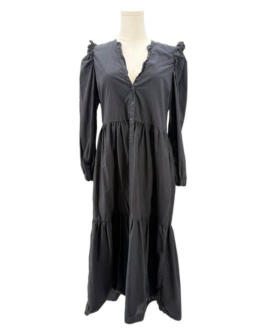 nation LA black dress with ruffled shoulders on a mannequin against a white background