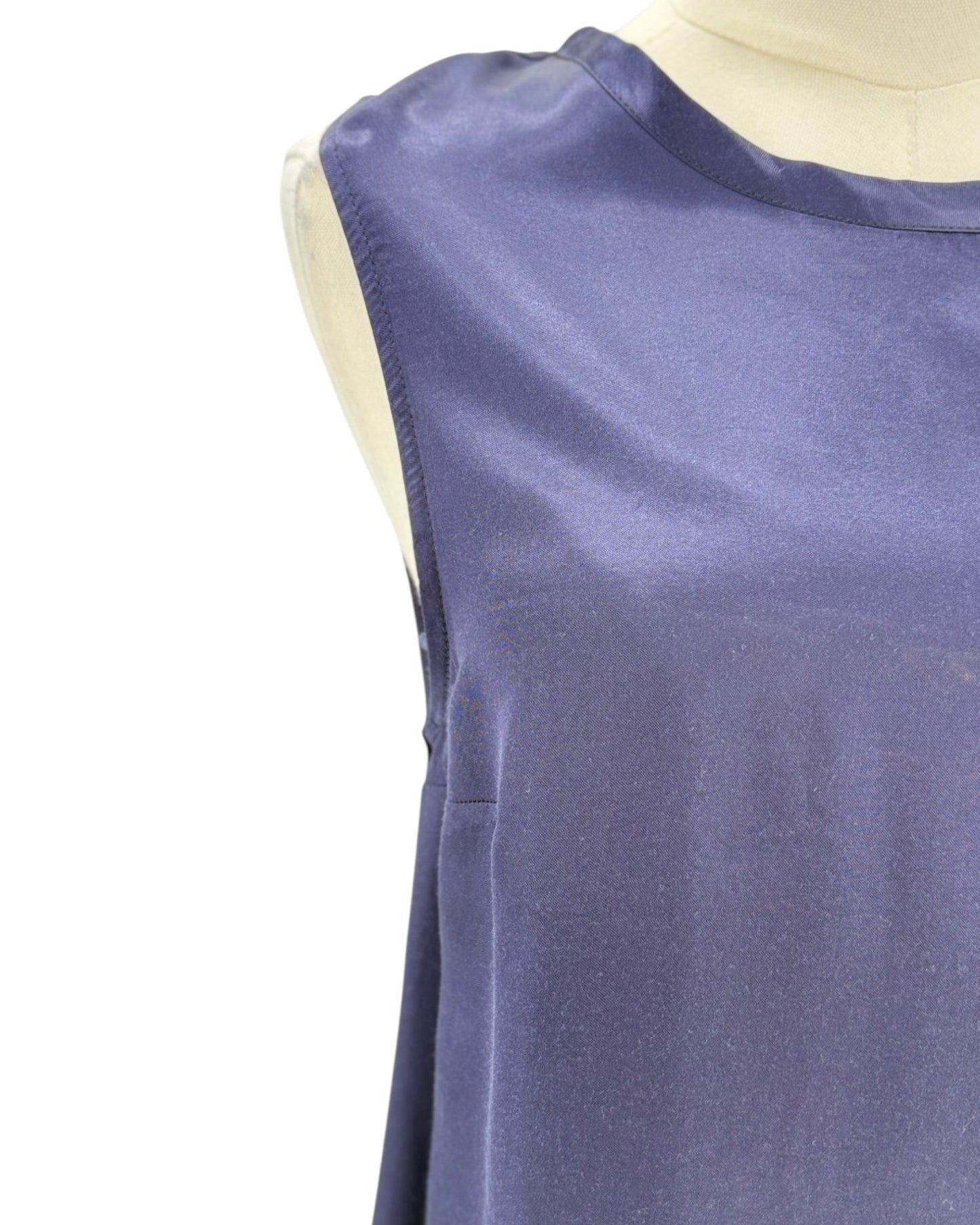 Blue sleeveless top on a mannequin against a white background