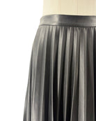 Black pleated skirt on a mannequin against a white background