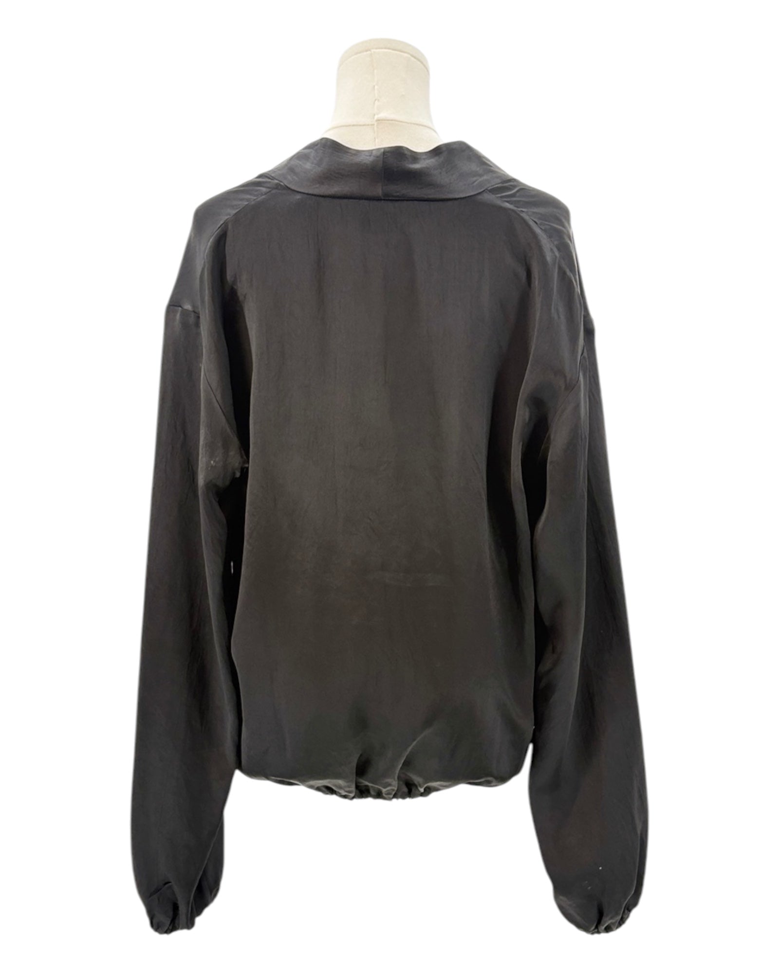 Black blouse on a mannequin against a white background