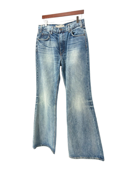 Pair of blue jeans on a hanger against a white background
