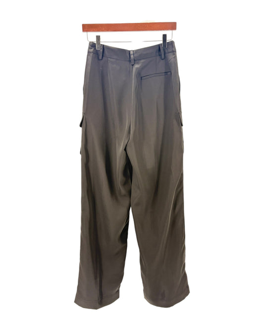 black pants hanging on a wooden rack against a white background