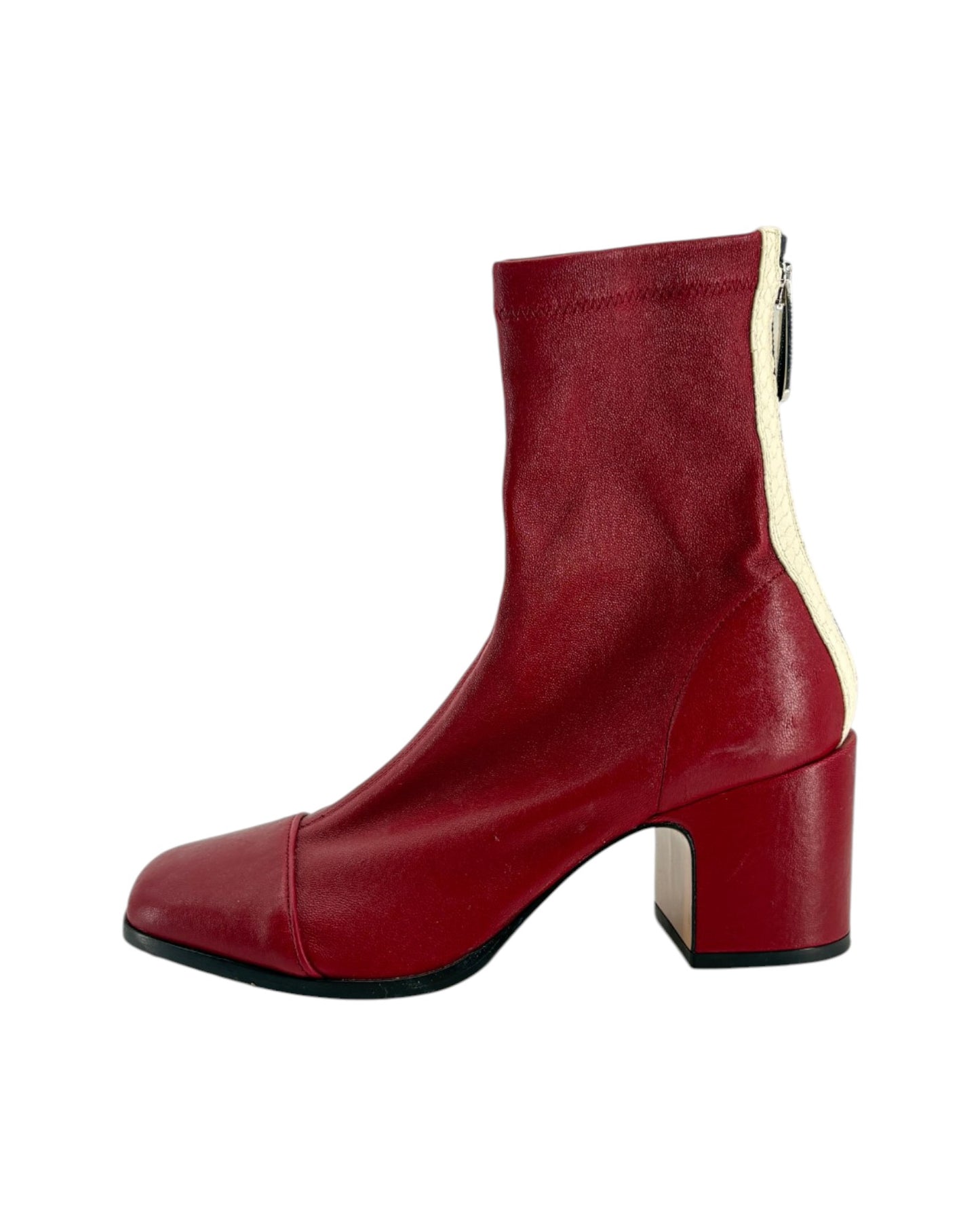 Red ankle boot with a block heel on a white background