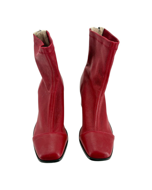 Pair of red leather boots on a white background