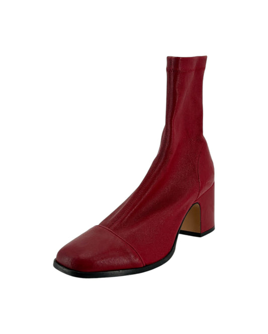 Red boot with a block heel on a white background