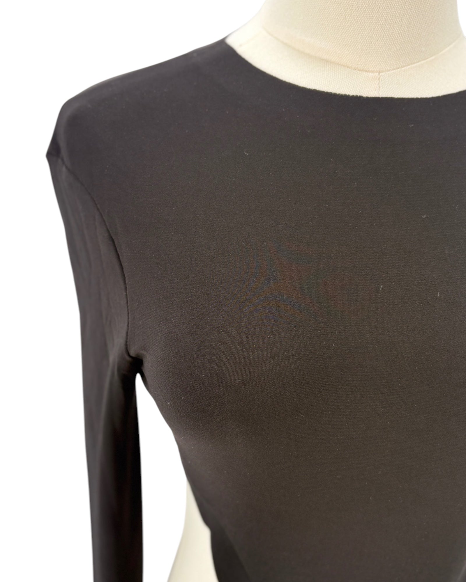 Black long-sleeve shirt on a mannequin against a white background