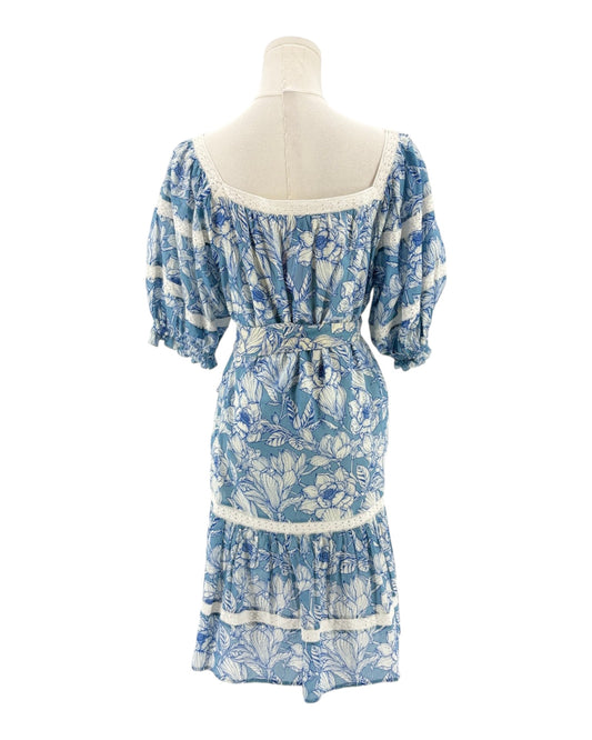 Blue floral dress on a mannequin against a white background
