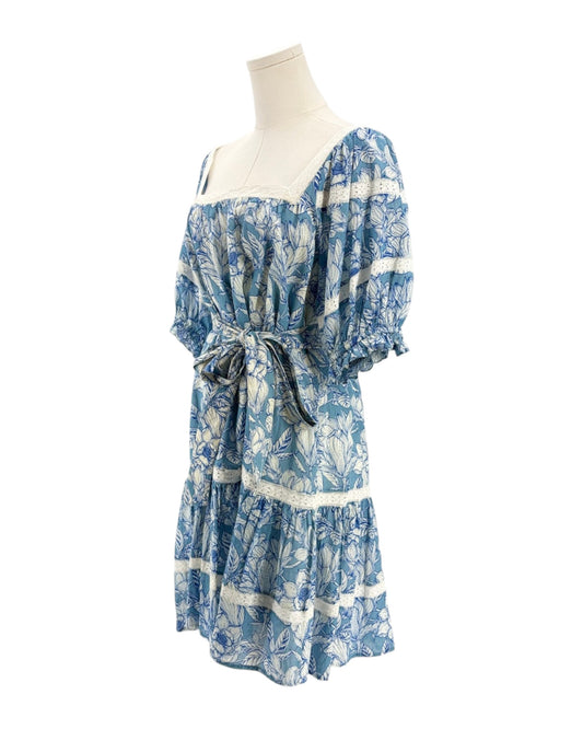 Blue floral dress on a mannequin against a white background