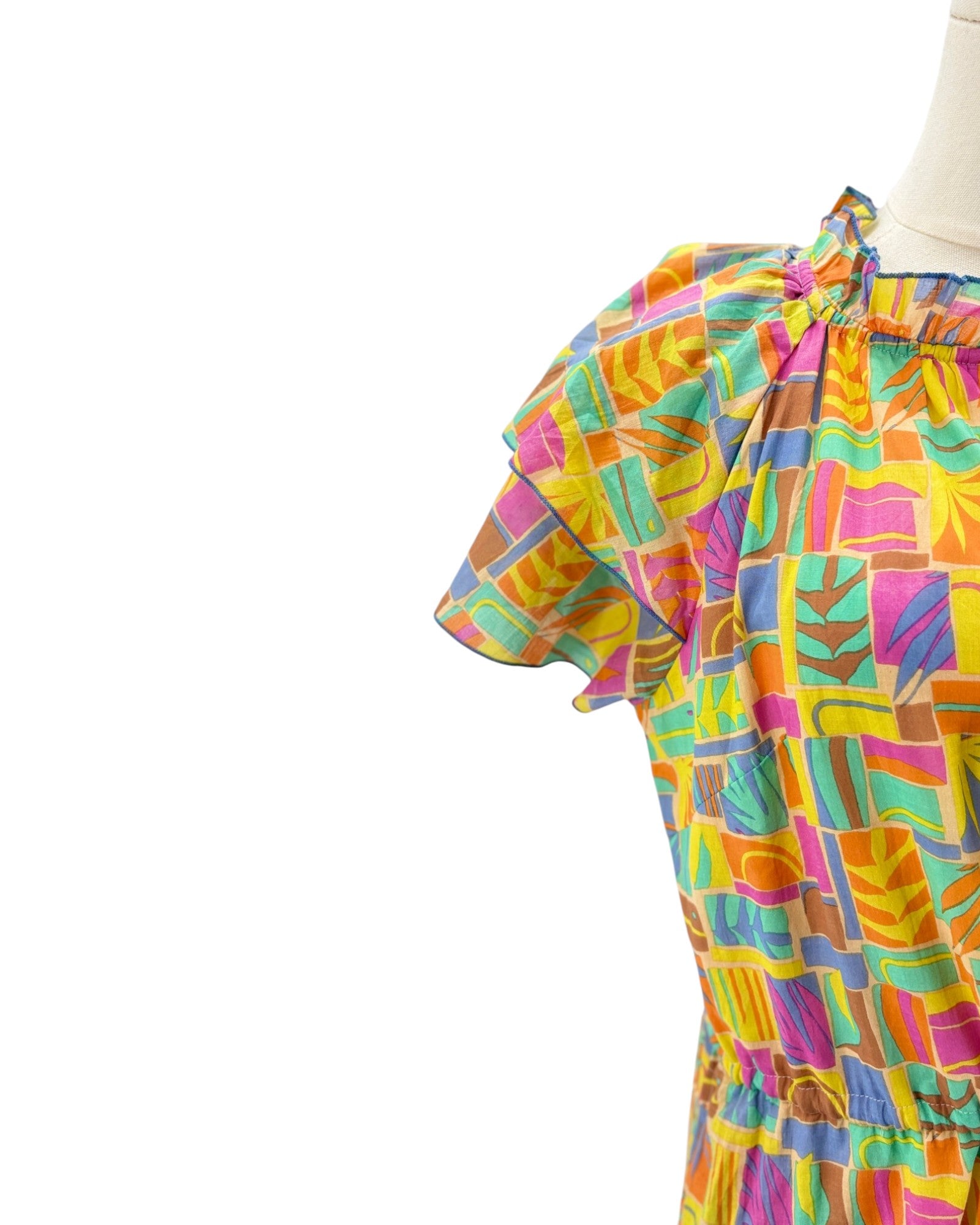 Multicolored mini dress on a mannequin on a white background