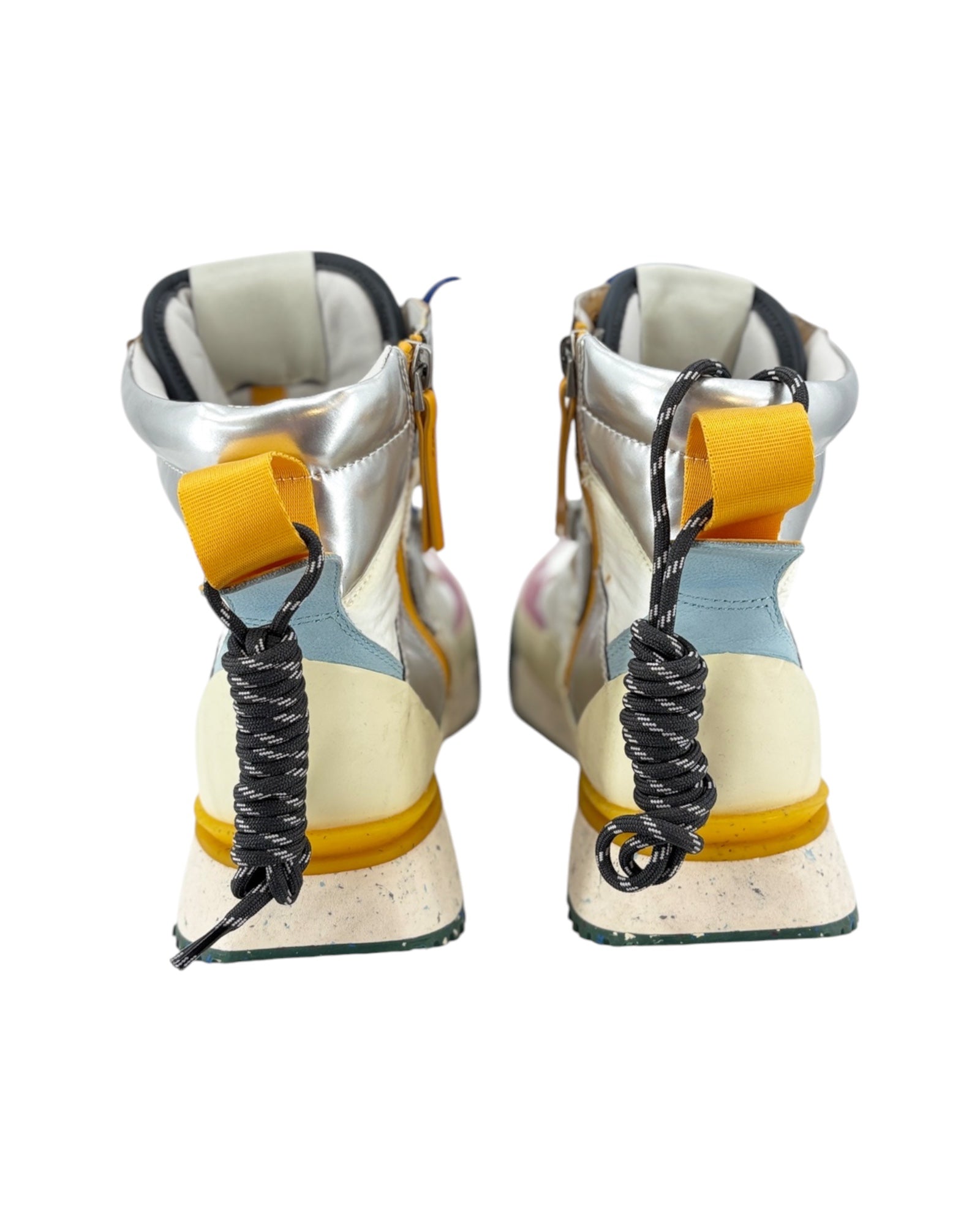 Pair of high-top sneakers with yellow accents and coiled laces on a white background