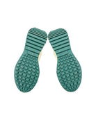 Green textured shoe sole on a white background