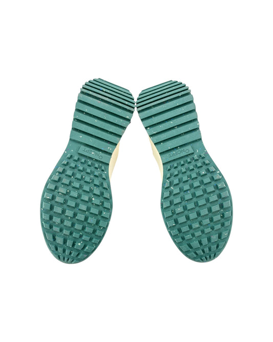 Green textured shoe sole on a white background