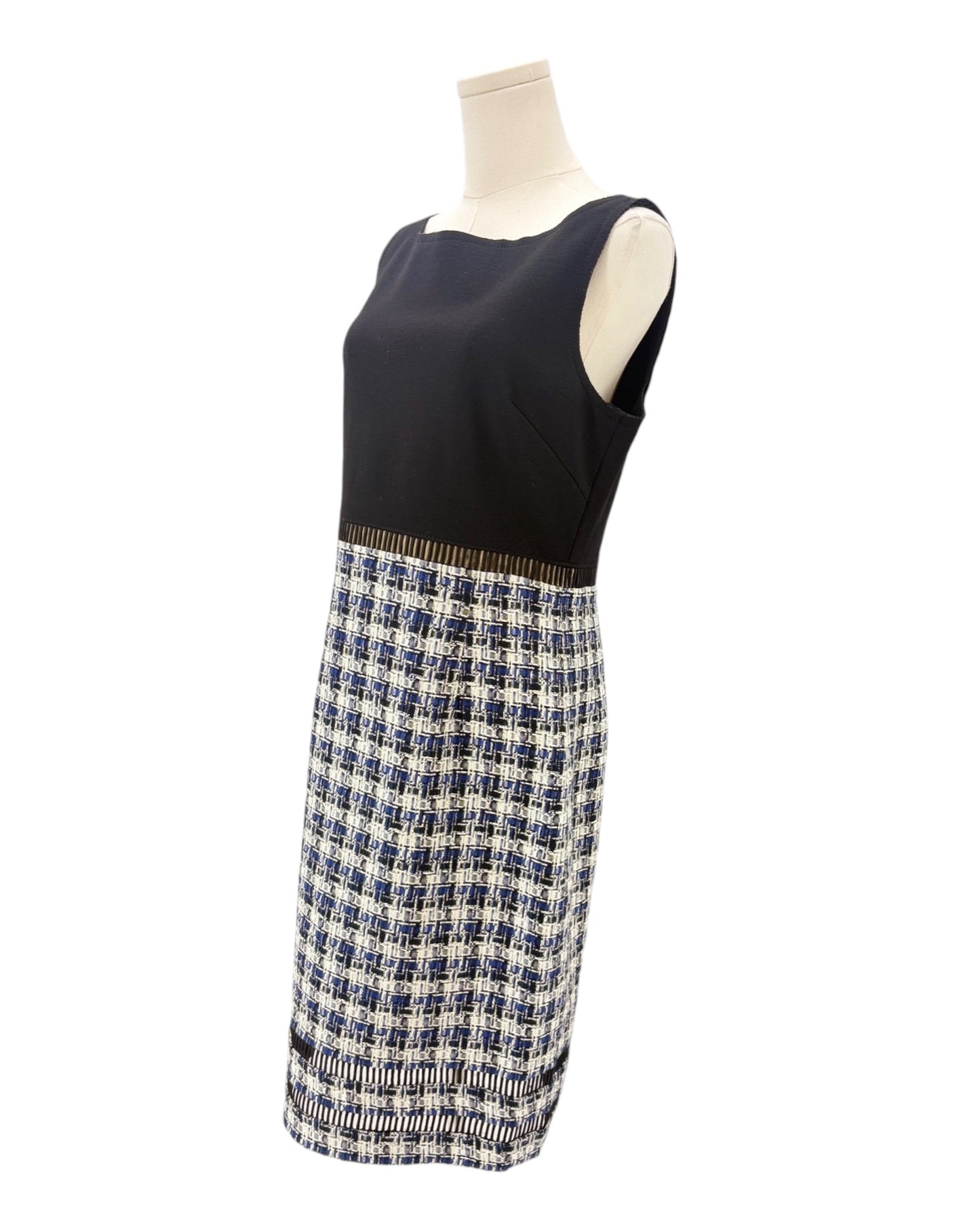 Navy sleeveless dress with a blue and white skirt on a mannequin against a white background