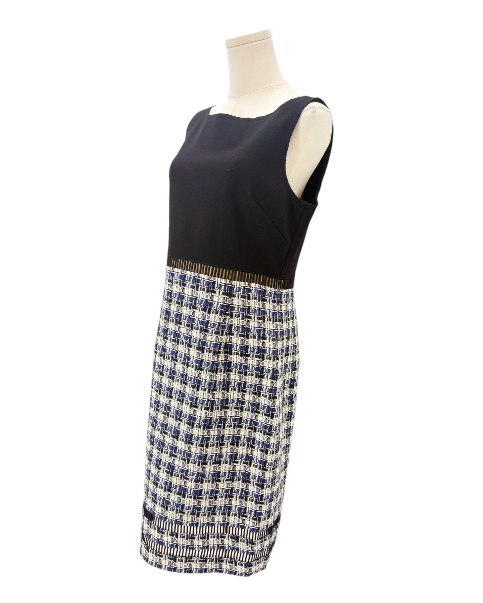 Navy sleeveless dress with a blue and white skirt on a mannequin against a white background
