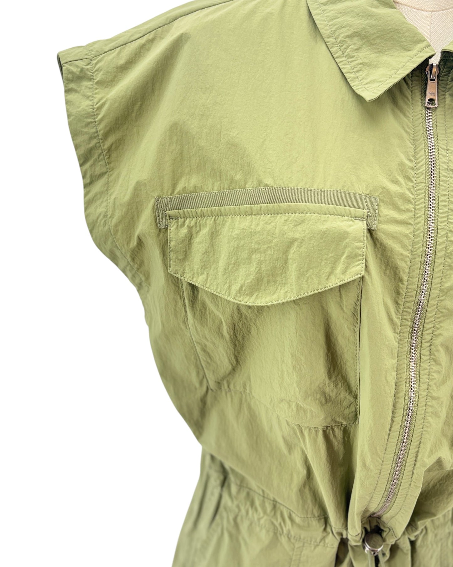Green sleeveless mini dress on a mannequin against a white background