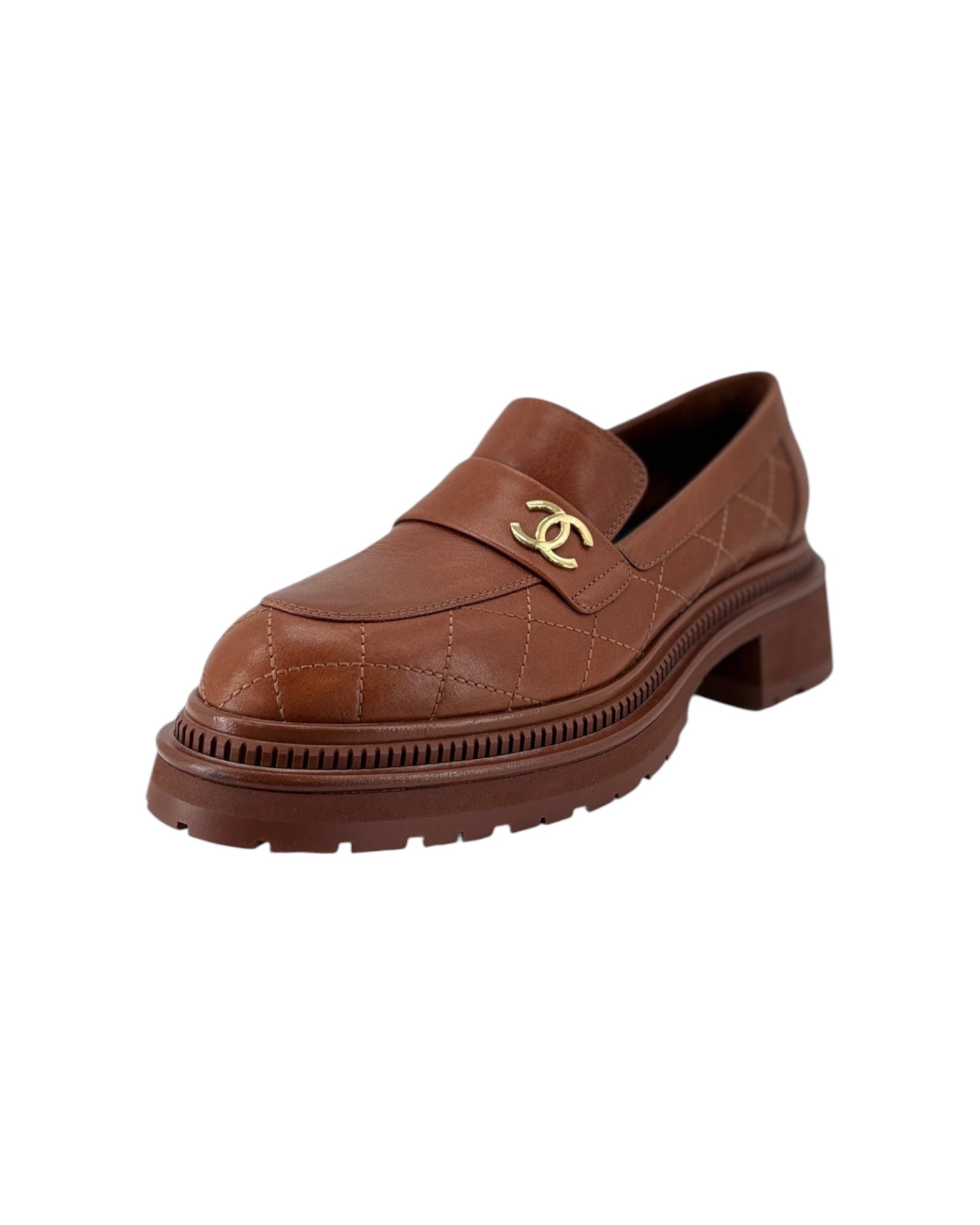 Pair of Chanel brown loafers with gold CC logo on a white background