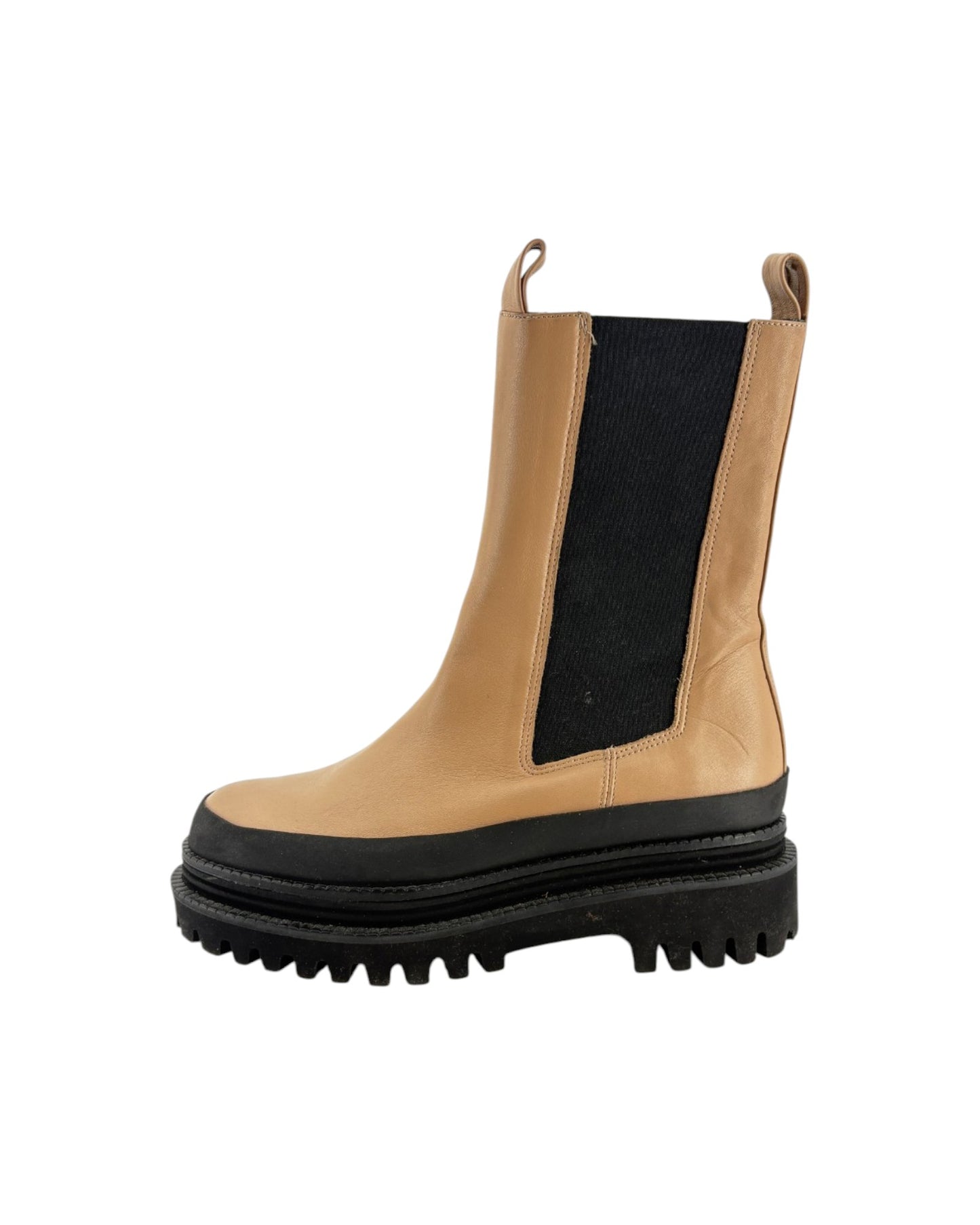 Tan leather boot with black sole on a white background