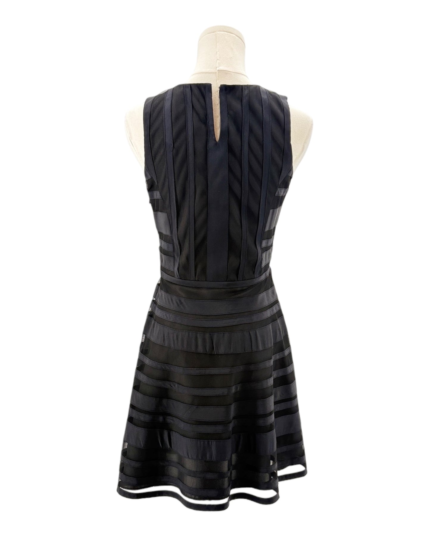 Black dress on a mannequin against a white background