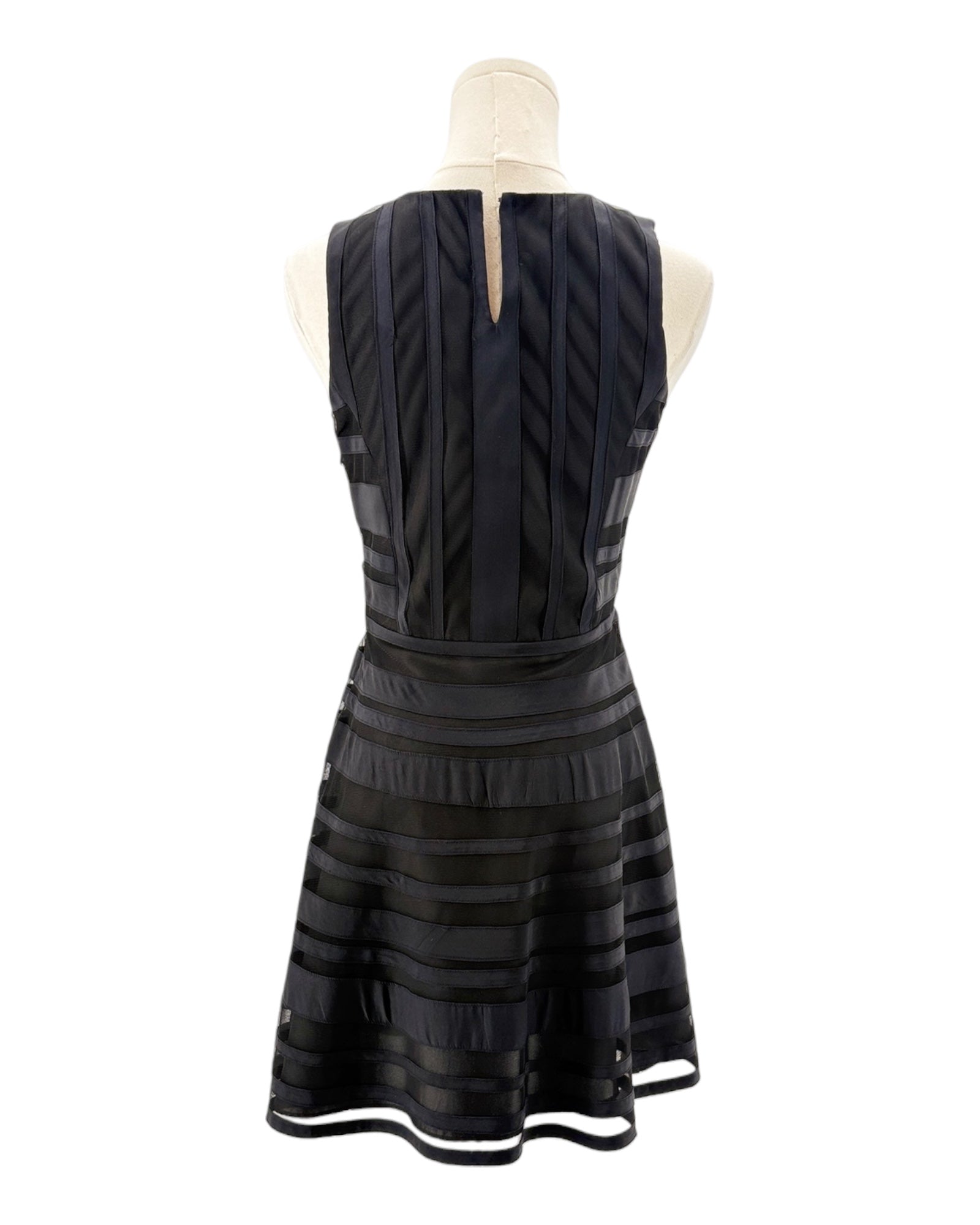 Black dress on a mannequin against a white background
