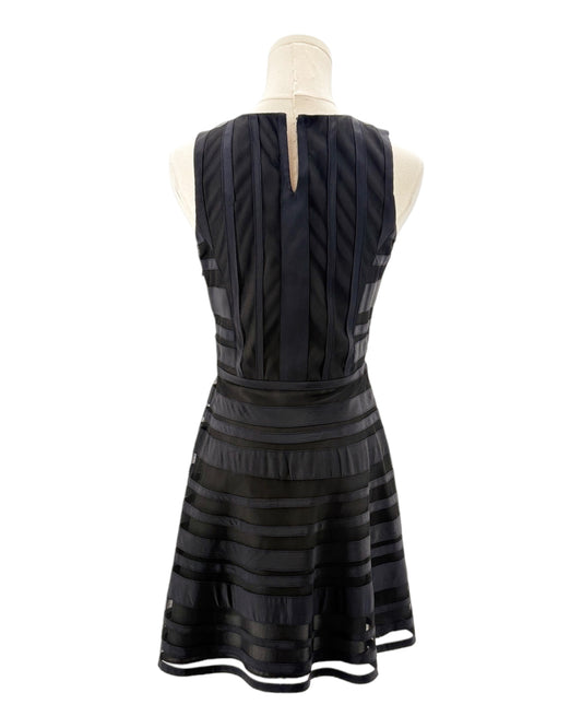 Black dress on a mannequin against a white background