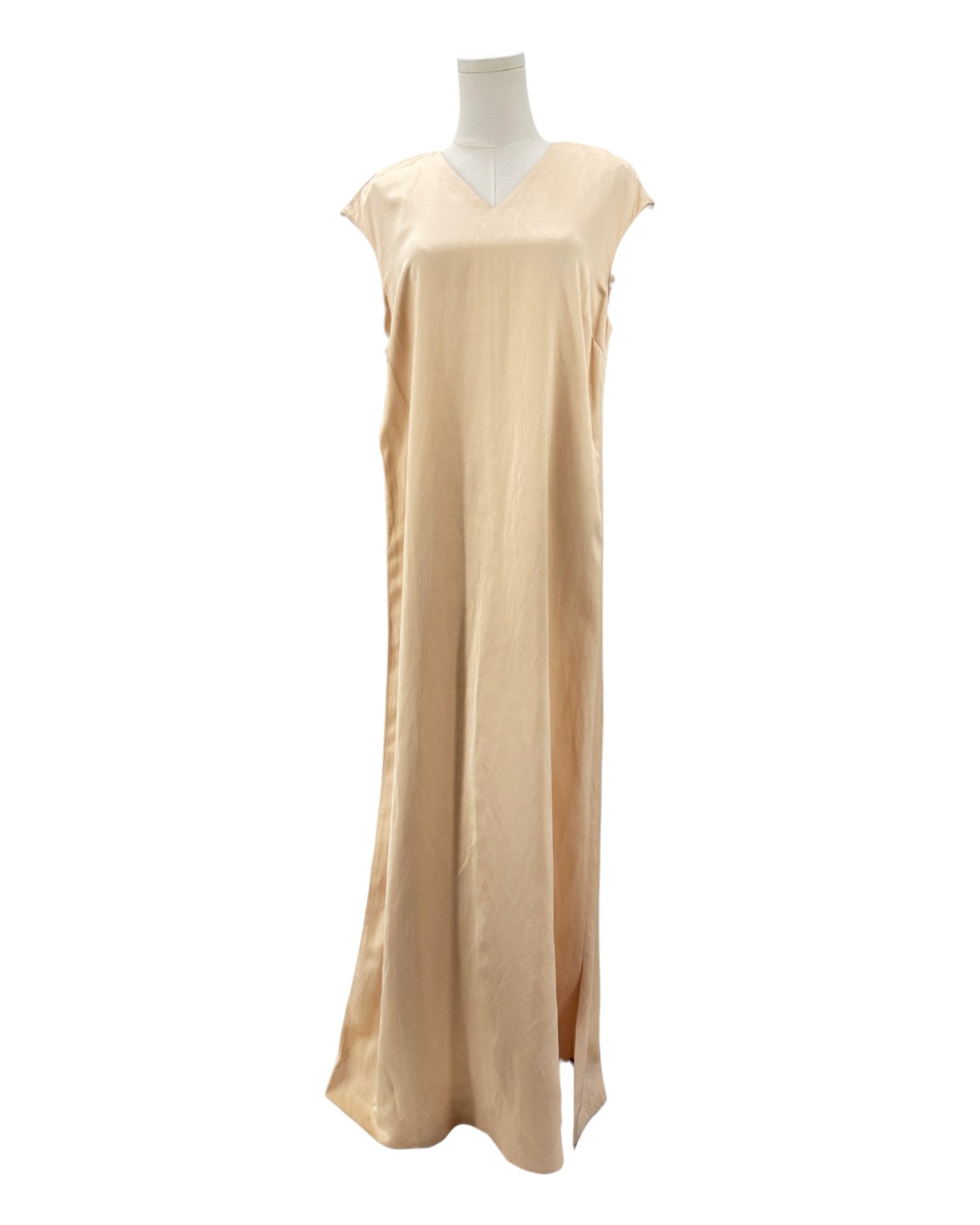 Beige dress on a mannequin against a white background
