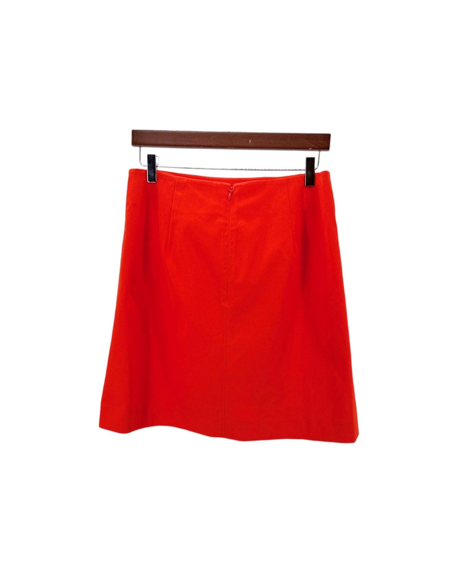 Red skirt on a hanger against a white background