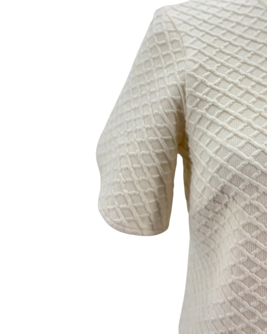 Close-up of a textured white sweater on a white background