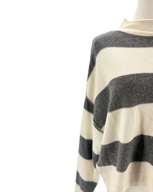 Mannequin wearing a sweater with black and white horizontal stripes on a white background