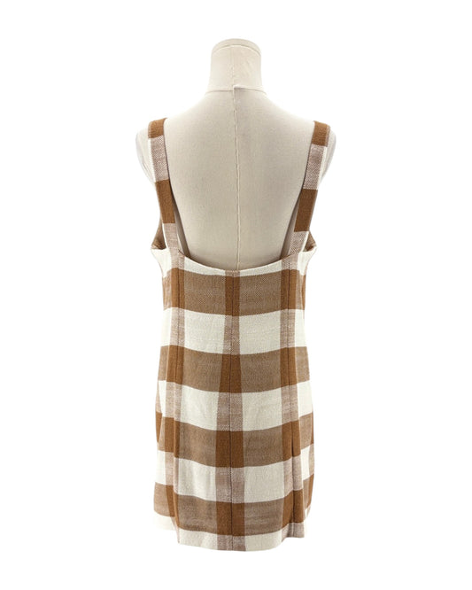 Brown and white checkered dress on a mannequin against a white background