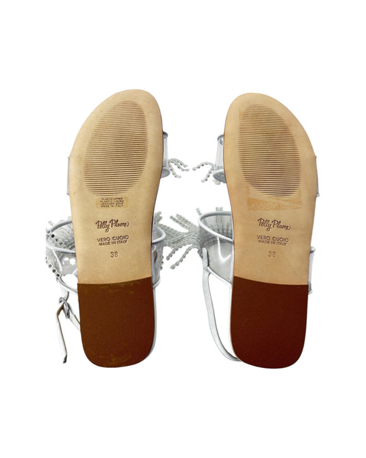 Close-up of the soles of a pair of shoes with visible branding on a white background