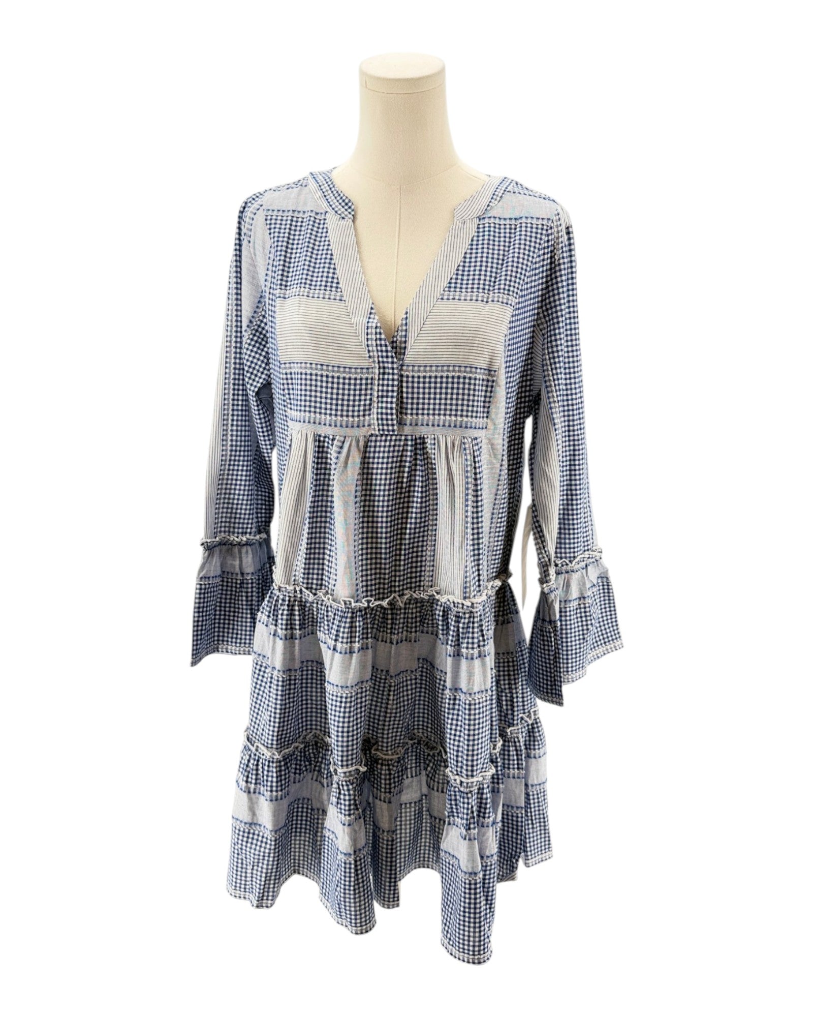 Blue and white checkered dress on a mannequin against a white background
