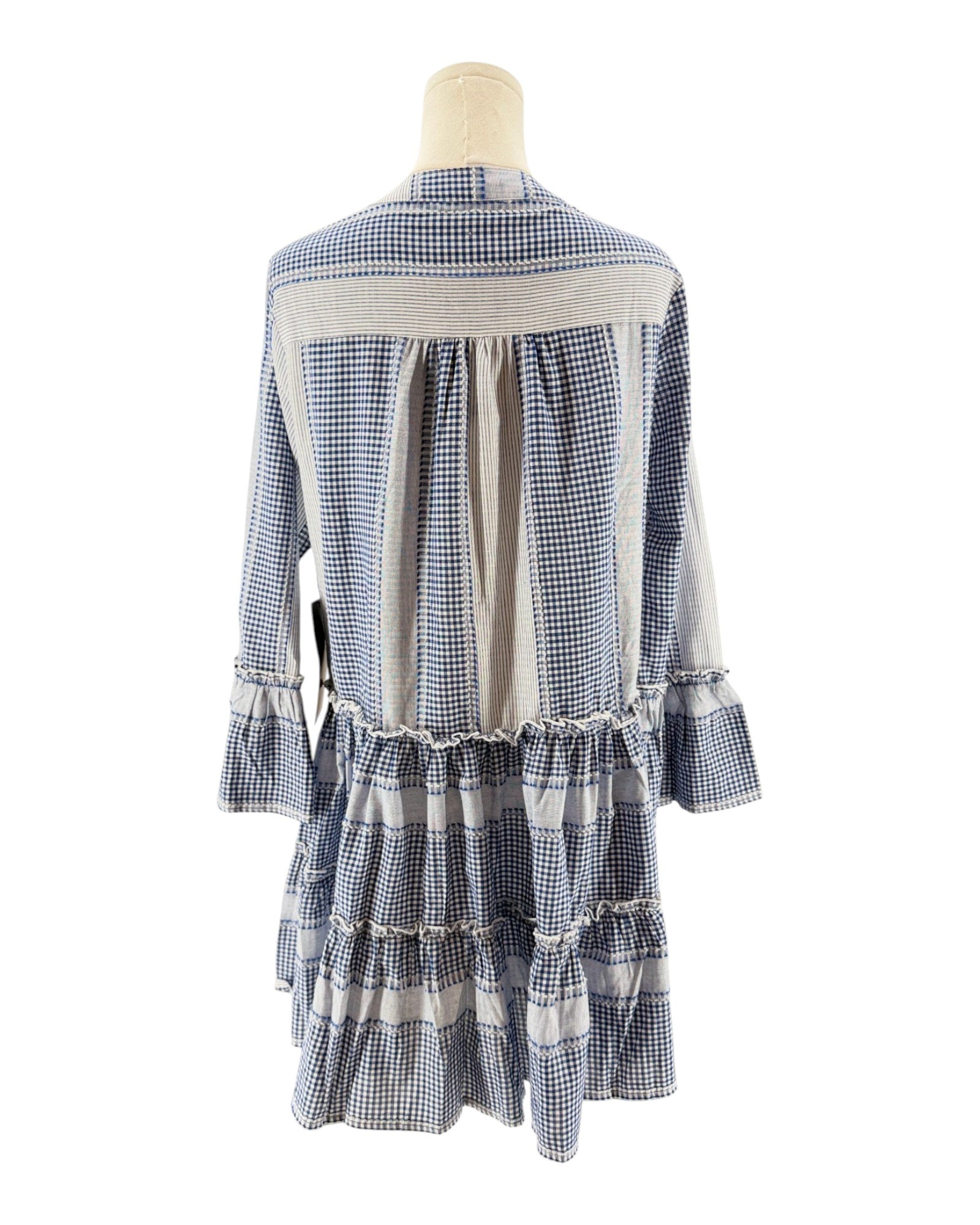 Blue and white checkered dress on a mannequin against a white background