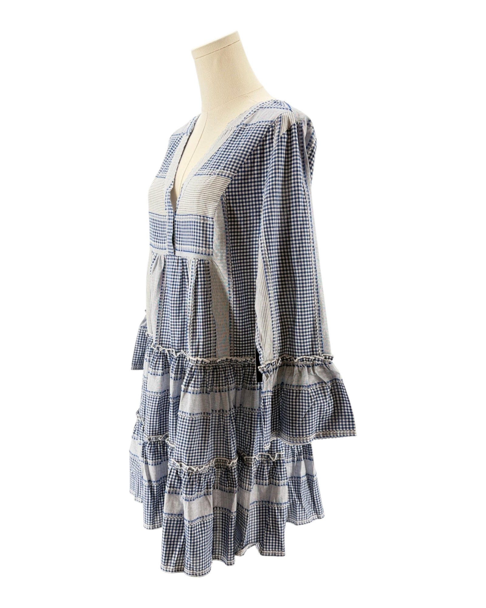 Blue and white checkered dress on a mannequin against a white background
