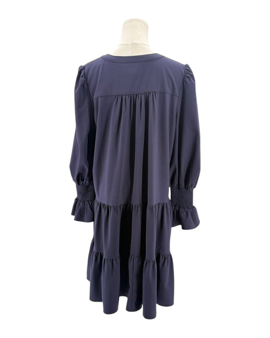 Navy blue dress on a mannequin against a white background