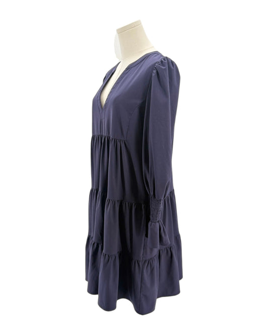 Navy blue dress on a mannequin against a white background