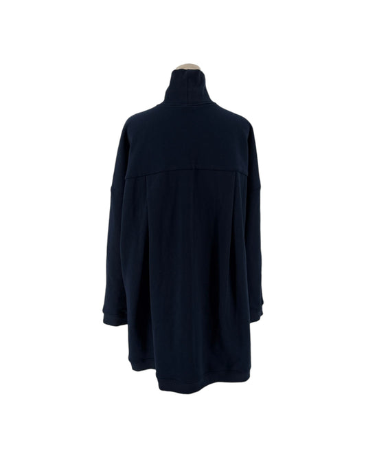 Navy oversized silhouette, high mock/turtleneck, long sleeves, two distinctive large patch pockets on the front on a mannequin on a white background