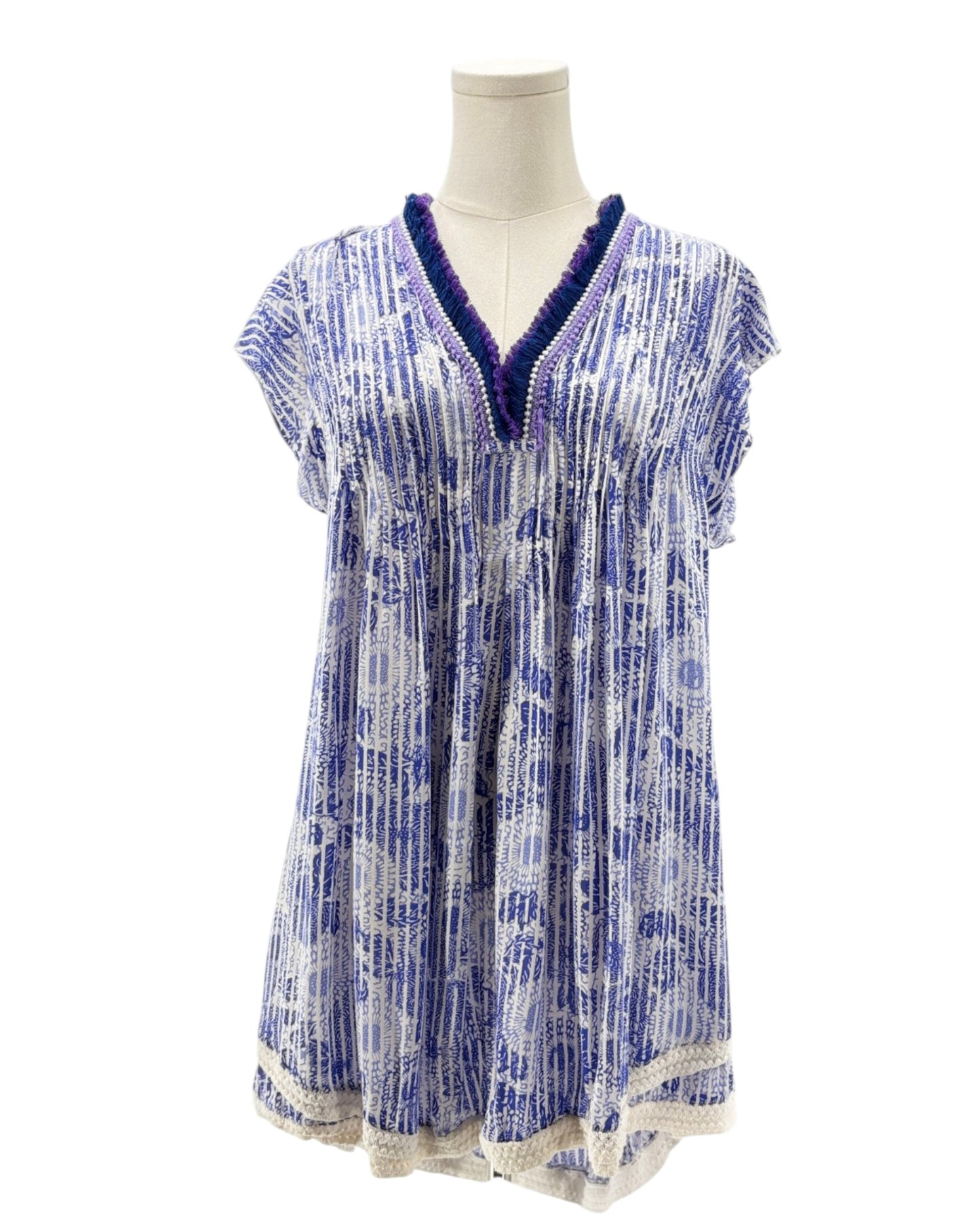 Blue and white patterned dress on a mannequin against a white background