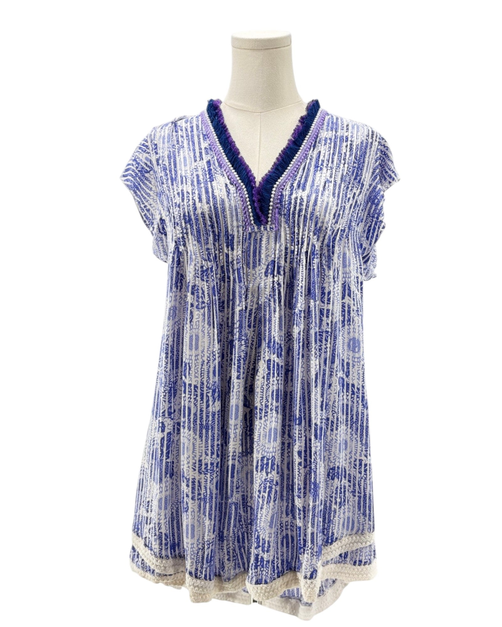 Blue and white patterned dress on a mannequin against a white background