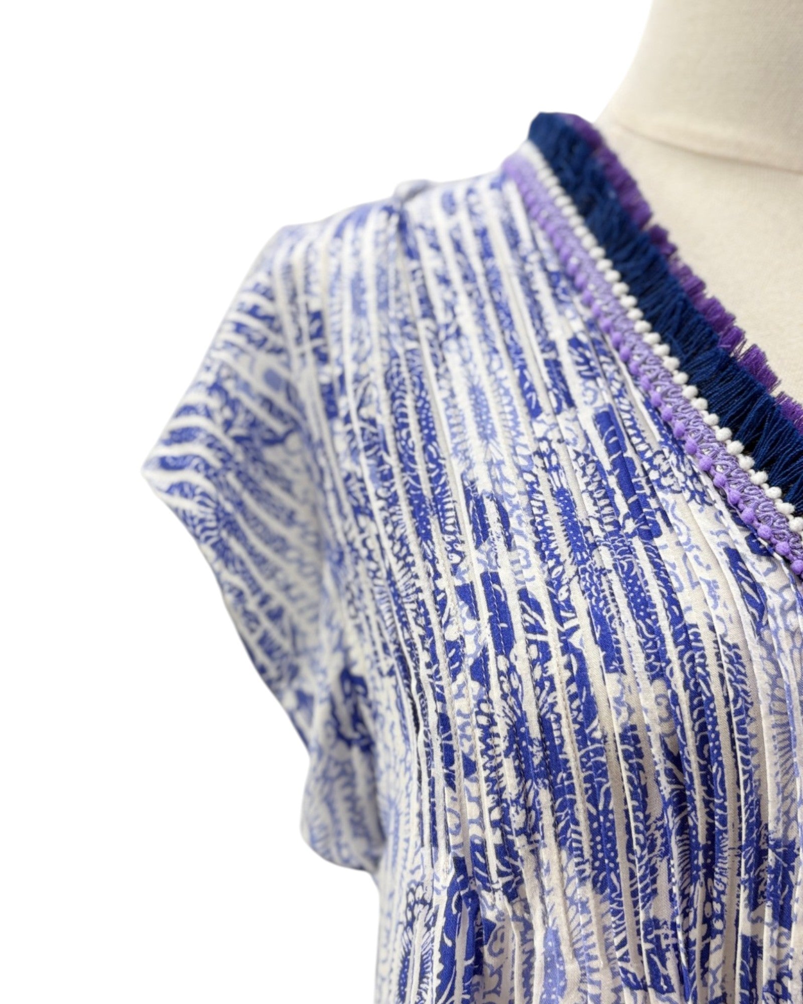Textured fabric with blue and white pattern on a mannequin against a white background