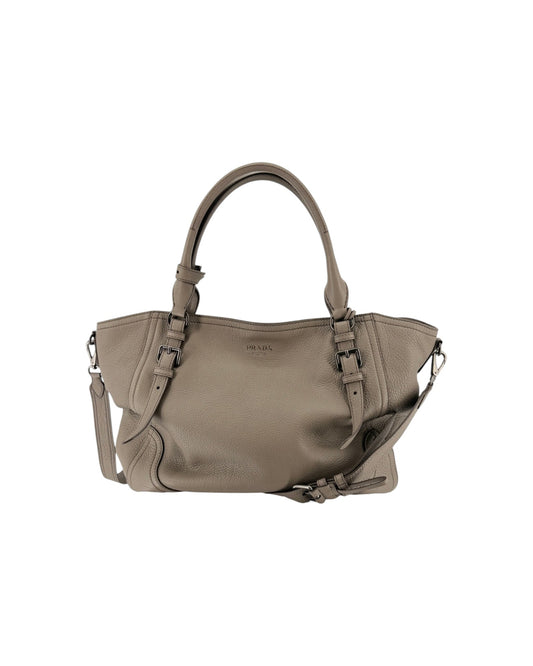 Large grey leather tote handbag with silver hardware and silver letting PRADA on a white background