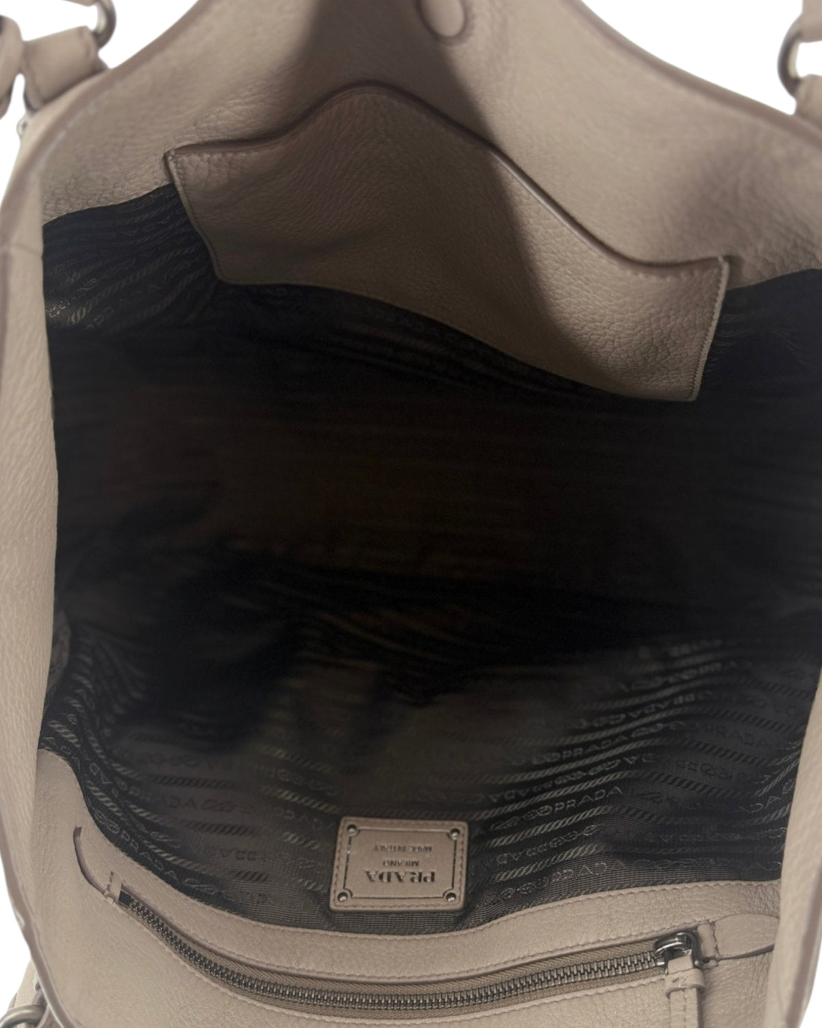 Interior of a large handbag with a PRADA tag 